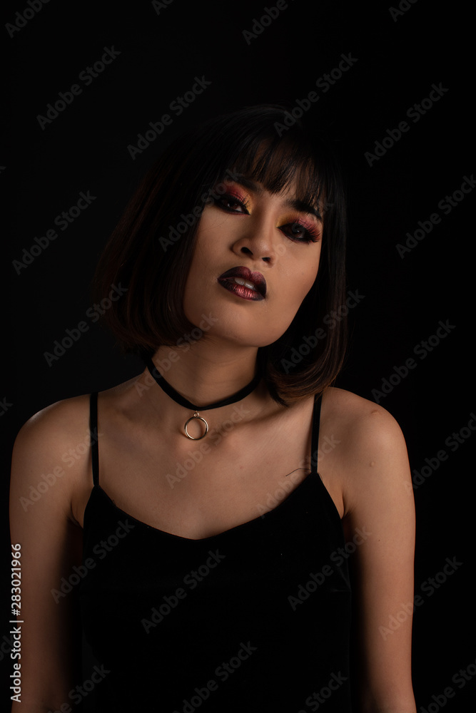 Southeast asian woman with dark tone makeup on black background, portrait photography Southeast asian woman with dark tone makeup on black background, portrait photography