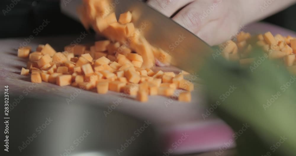 Chopping carrots on a cutting boards in gastronomic restaurant, Chef prepare vegetables Chopping carrots on a cutting boards in gastronomic restaurant, Chef prepare vegetables
