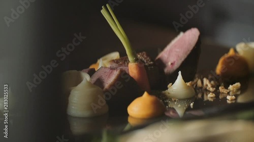 Chef is finishing a gourmet meal, teasty duck breast, beautiful plate, colorful plate,  French chef cooking a duck breast in a  Gastronomic restaurant photo