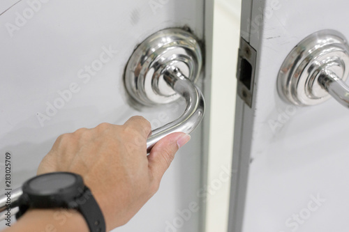Selective focus of  Hand on Stainless Steel Door Handles