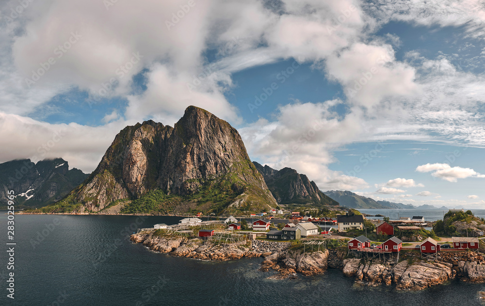 Reine fishing village in lofoten islands with traditional rorbu huts in a summer day wide panoramic view.