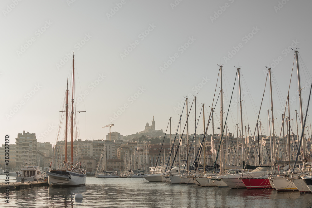 Central city harbor in downtown with many boats and yachts at sundown in Marseille, France, scenic view