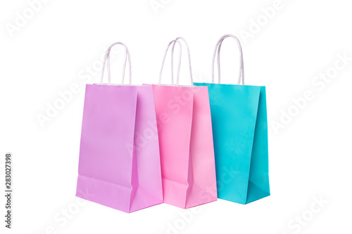 Three paper pink, purple,blue shopping bags isolated. Top view.