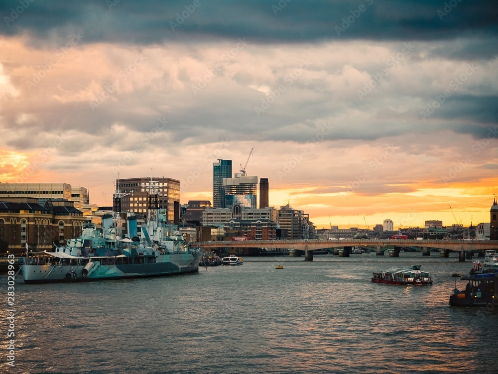 London. View of London at sunset time. Beautiful famous English Landmarks. Thames River. Ships and boats in London.