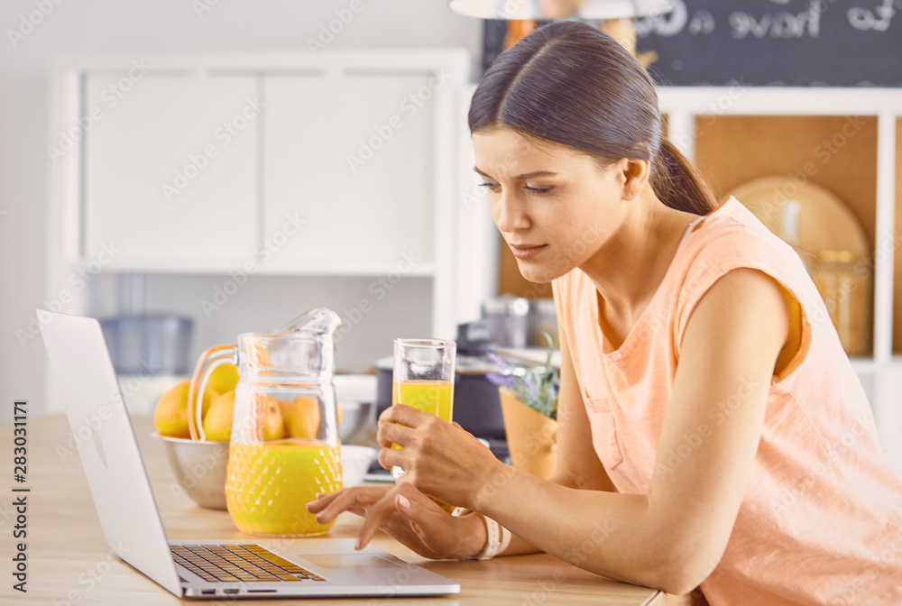 Smiling pretty woman looking at mobile phone and holding glass Smiling pretty woman looking at mobile phone and holding glass