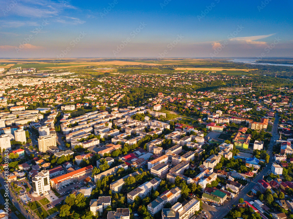 Aerial view of Slatina city and river Olt, Romania. Drone flight over the european city in summer day.