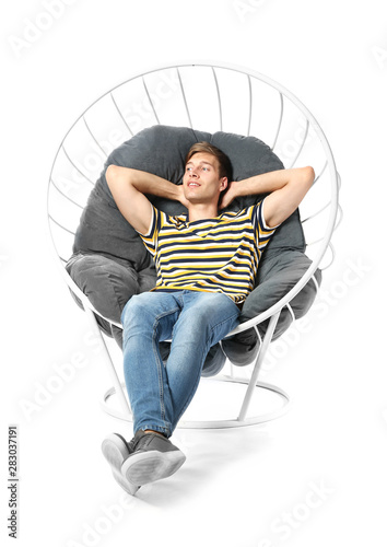 Young man relaxing in armch...