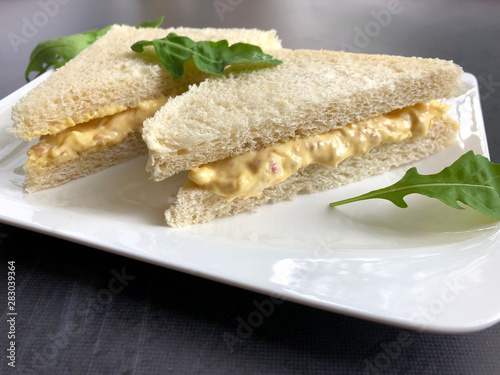 Tramezzini is a classic, Italian sandwich. Sliced white bread with egg spread. Tramezzinis are offered as a snack or appetizer.