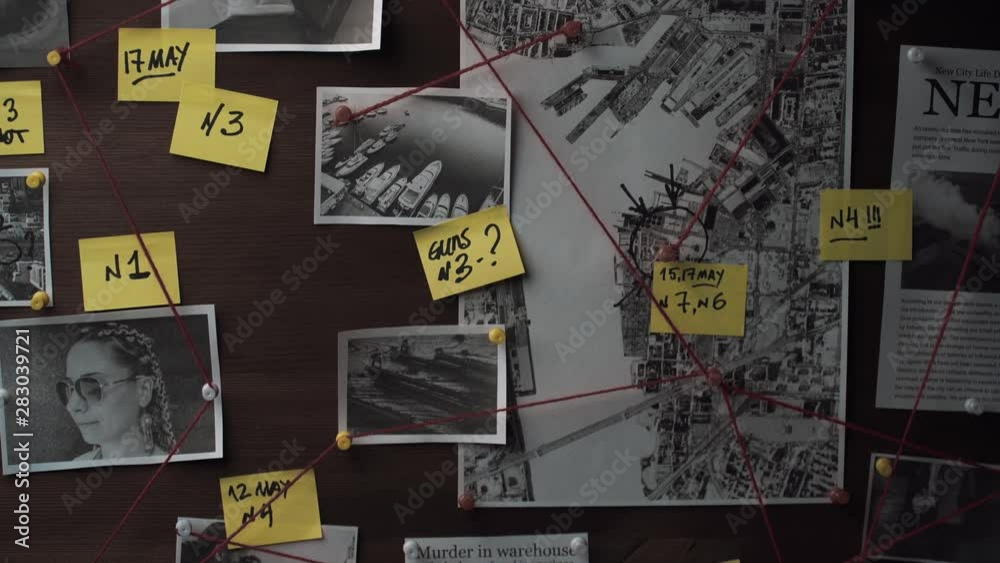 Detective board with photos of suspected criminals, crime scenes and evidence with red threads