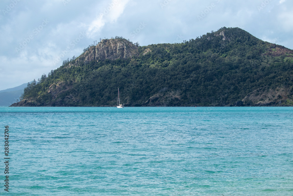 Yacht sailing amongst a tropical island setting