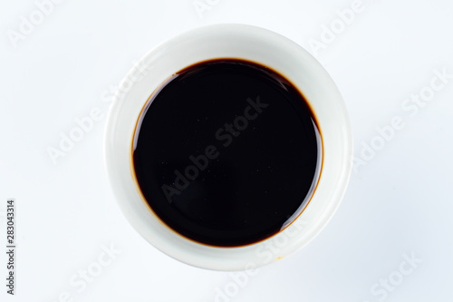 Thick dark soy sauce on a light background