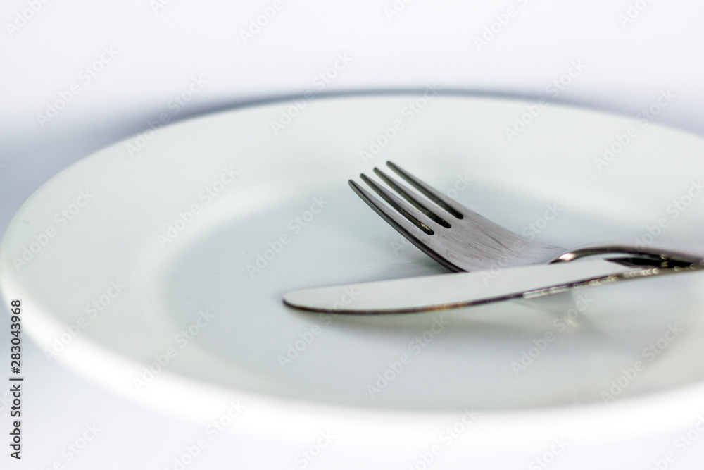 White empty plate with fork and knife White empty plate with fork and knife