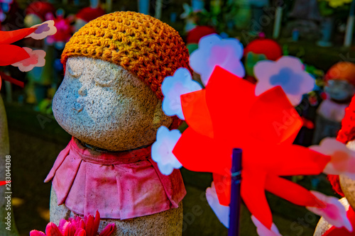 Statue guardian wearing red hat in Tokyo daytime photo