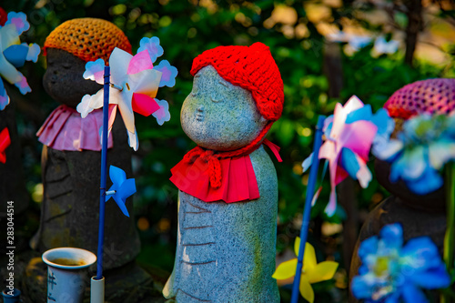 Statue guardian wearing red hat in Tokyo daytime photo