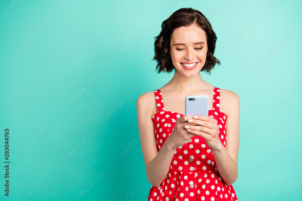 Pretty lady holding telephone hands wear red dotted dress isolated teal background Pretty lady holding telephone hands wear red dotted dress isolated teal background
