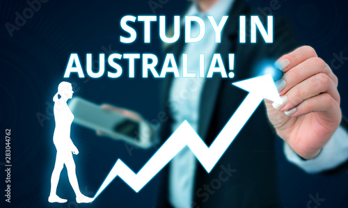 Conceptual hand writing showing Study In Australia. Concept meaning going into foreign country order complete your studies Female human wear formal work suit presenting smart device