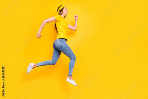Full length photo of pretty lady jumping high jogging wear casual clothes isolated yellow background