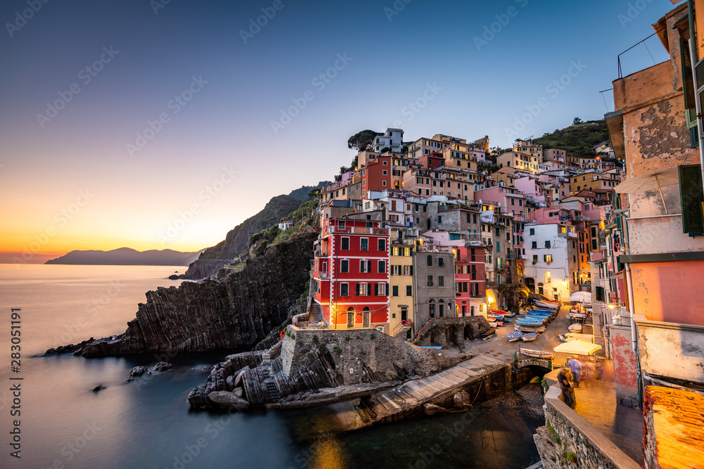Riomaggiore, Italy is a charming village built on a hillside above the Ligurian coast known for its colorful stone houses that seem stacked on top of one another.