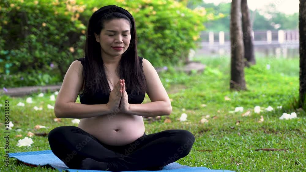 Beautiful Asian pregnant exercise in park in the morning Beautiful Asian pregnant exercise in park in the morning