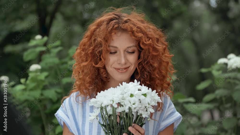 selective focus of happy girl holding flowers in park selective focus of happy girl holding flowers in park