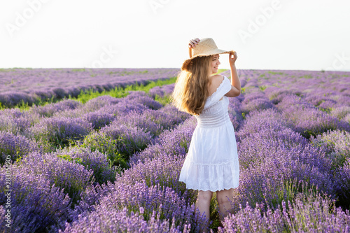 Fototapeta Naklejka Na Ścianę i Meble -  Woman in a white dress in a lavender field.