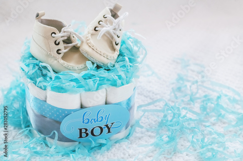 Present cake with diapers for newborn baby boy