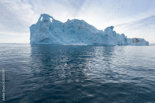 Nature and landscapes of Greenland or Antarctica. Travel on the ship among ices. Studying of a phenomenon of global warming Ices and icebergs of unusual forms and colors Beautiful sunny and cloudy day © Michal