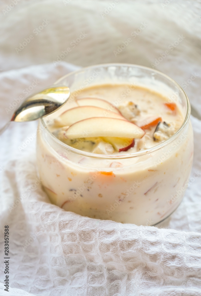 selective focus, still life, Breakfast. berry light peach yogurt with cereals in a glass jar with peach slices on a white tablecloth selective focus, still life, Breakfast. berry light peach yogurt with cereals in a glass jar with peach slices on a white tablecloth
