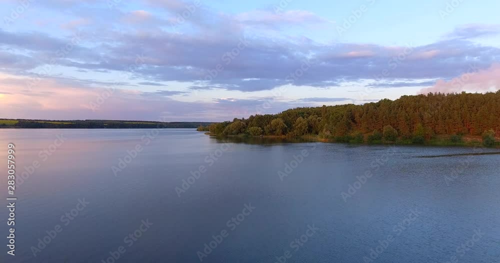 Aerial shot above lake and forest while sunset. Beautiful river and forest while sunset. Drone Footage. Aerial shot above lake and forest while sunset. Beautiful river and forest while sunset. Drone Footage.
