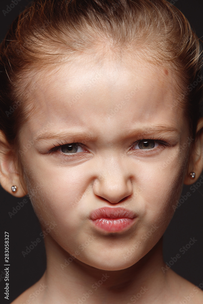 Close up portrait of little and emotional caucasian girl. Highly detail photoshot of female model with well-kept skin and bright facial expression. Concept of human emotions. Disgusting. Close up portrait of little and emotional caucasian girl. Highly detail photoshot of female model with well-kept skin and bright facial expression. Concept of human emotions. Disgusting.