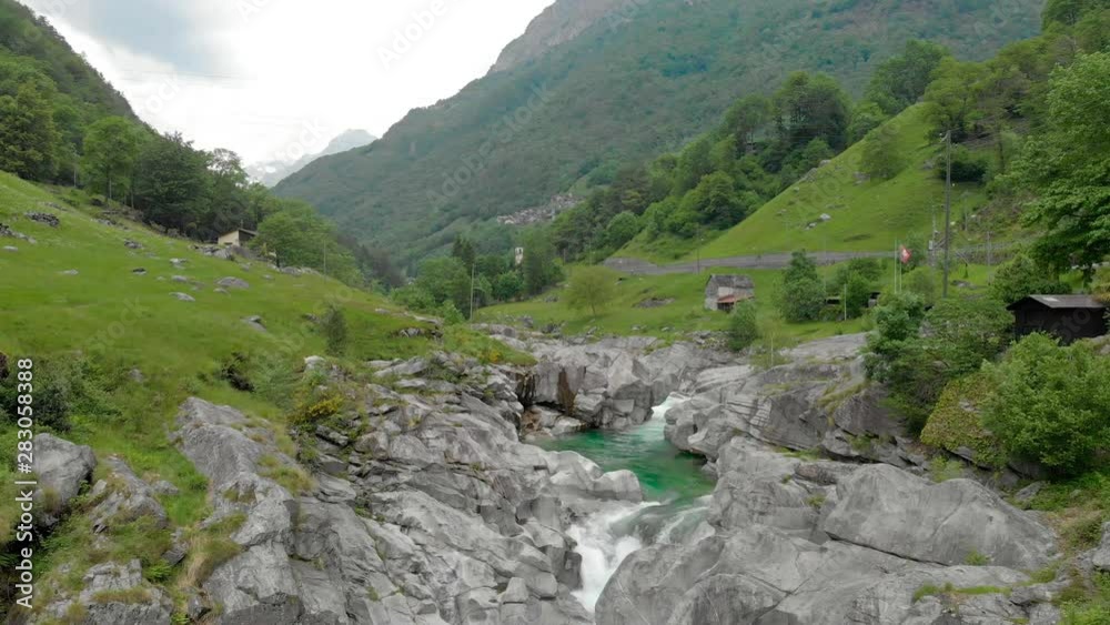 Valle Verzasca - Aerial View of clear and turquoise water stream and rocks in Verzasca River in Ticino - Verzasca Valley in Tessin, Switzerland Valle Verzasca - Aerial View of clear and turquoise water stream and rocks in Verzasca River in Ticino - Verzasca Valley in Tessin, Switzerland