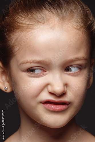 Close up portrait of little and emotional caucasian girl. Highly detail photoshot of female model with well-kept skin and bright facial expression. Concept of human emotions. Disgusting.