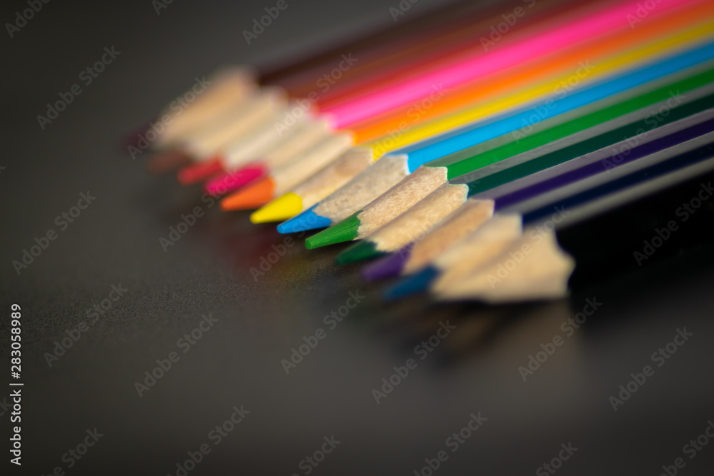 Colored pencils tips line-up green focus Colored pencils tips line-up green focus
