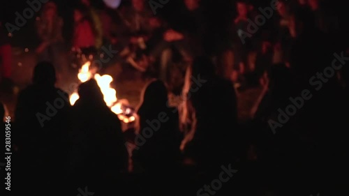 Friends having fun on the campfire. Young peoples Silhouettes sitting around campfire, romantic having rest friends girls boy woman man. Bonfire, camping silence calm summer holidays warm