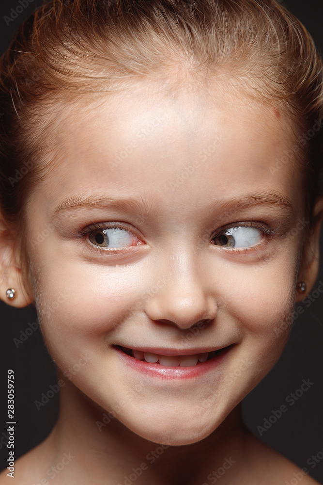 Close up portrait of little and emotional caucasian girl. Highly detail photoshot of female model with well-kept skin and bright facial expression. Concept of human emotions. Playful, looking at side. Close up portrait of little and emotional caucasian girl. Highly detail photoshot of female model with well-kept skin and bright facial expression. Concept of human emotions. Playful, looking at side.