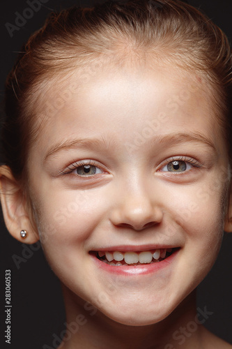 Close up portrait of little and emotional caucasian girl. Highly detail photoshot of female model with well-kept skin and bright facial expression. Concept of human emotions. Smiling  laughting.