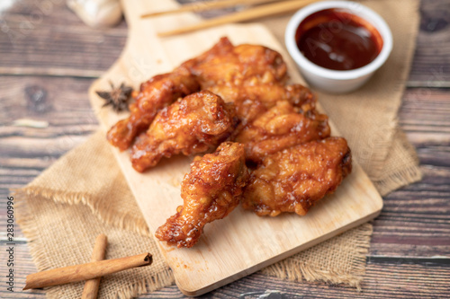 Hot and spicy Korean barbeque fried chicken on wood cutting board