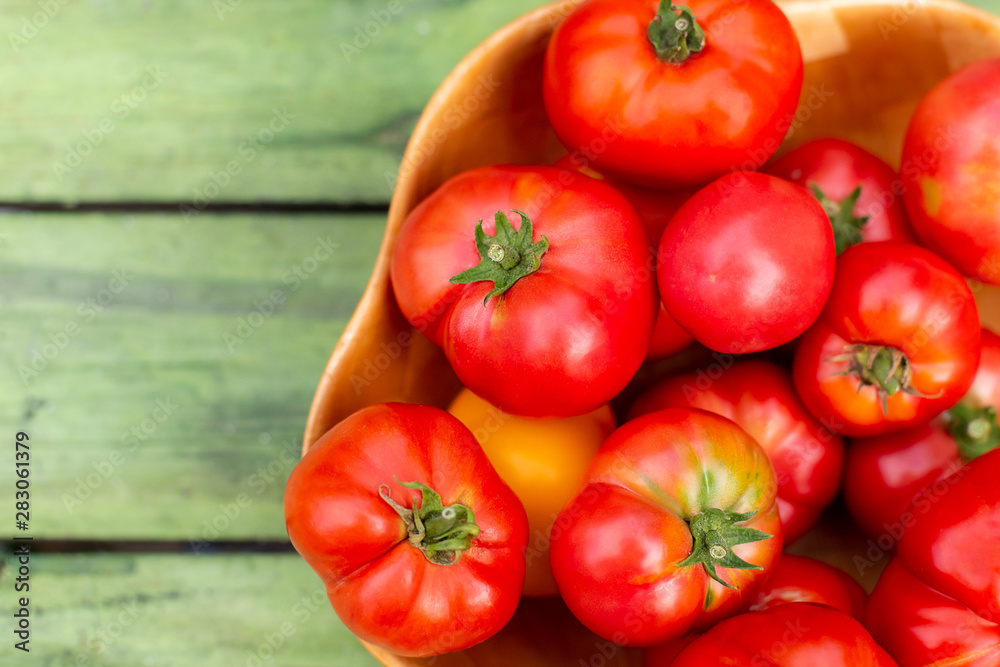 Tomato harvest in bamboo bowl Tomato harvest in bamboo bowl