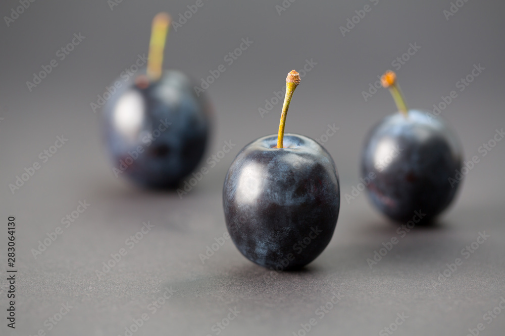 Whole plums in a macro studio shot