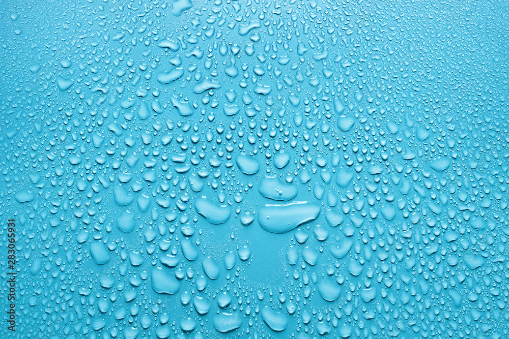 Water drops on smooth surface, light blue background