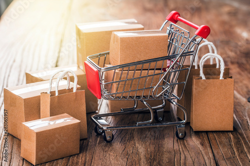 shopping online at home concept.Cartons in a shopping cart on a laptop keyboard.online shopping is a form of electronic commerce that allows consumers to directly buy goods from a seller over internet