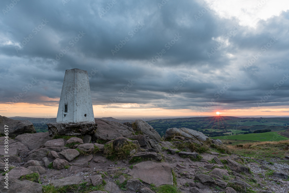 Trig point on top of The Roaches at sunset in the Peak District National Park.