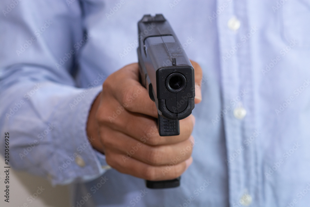Man shooting gun, close-up image Man shooting gun, close-up image