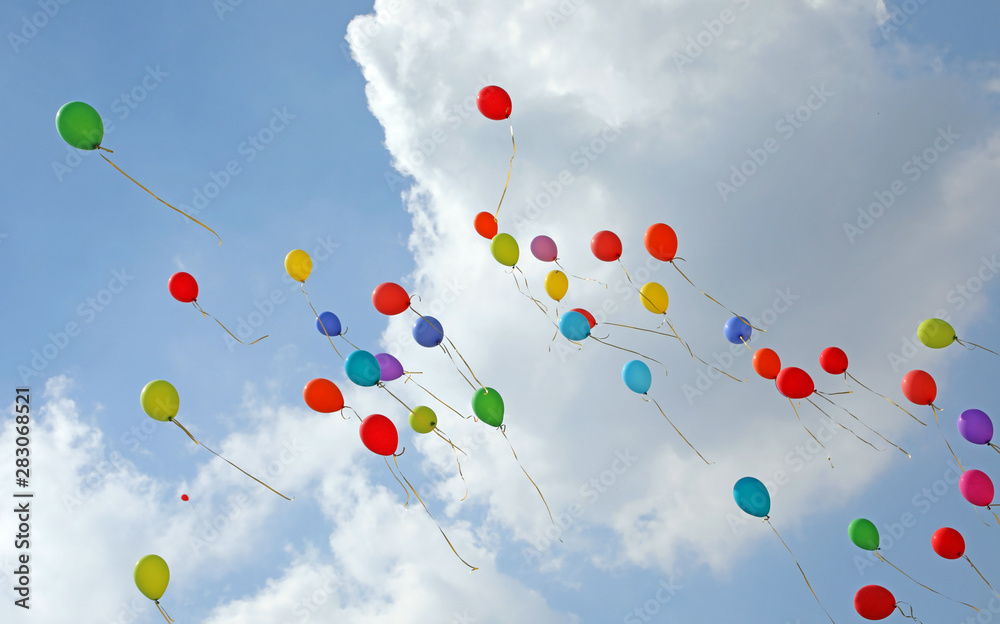 dozen of colored balloons in the sky with many white clouds symb dozen of colored balloons in the sky with many white clouds symb