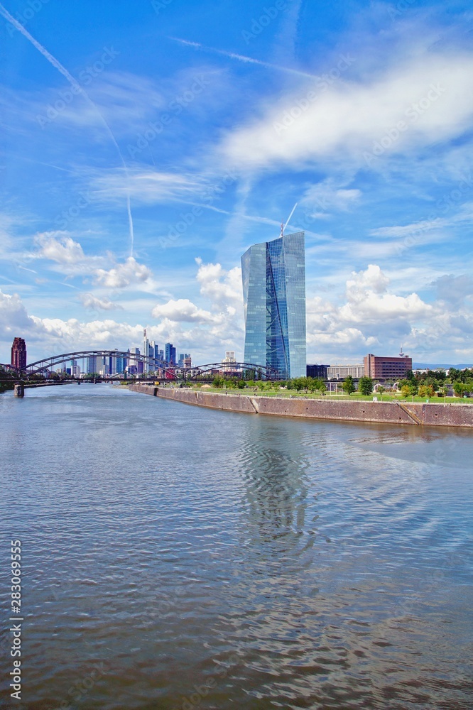 view of the river Main with the headquarters of ECB and the skyline of Frankfurt. European Central Bank and Skyscraper buildings in Germany with blue sky background. Business and finance concept