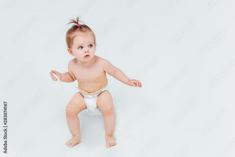 Portrait of small child holding on her hands a toy, curious baby looking up isolated on white. Portrait of small child holding on her hands a toy, curious baby looking up isolated on white.