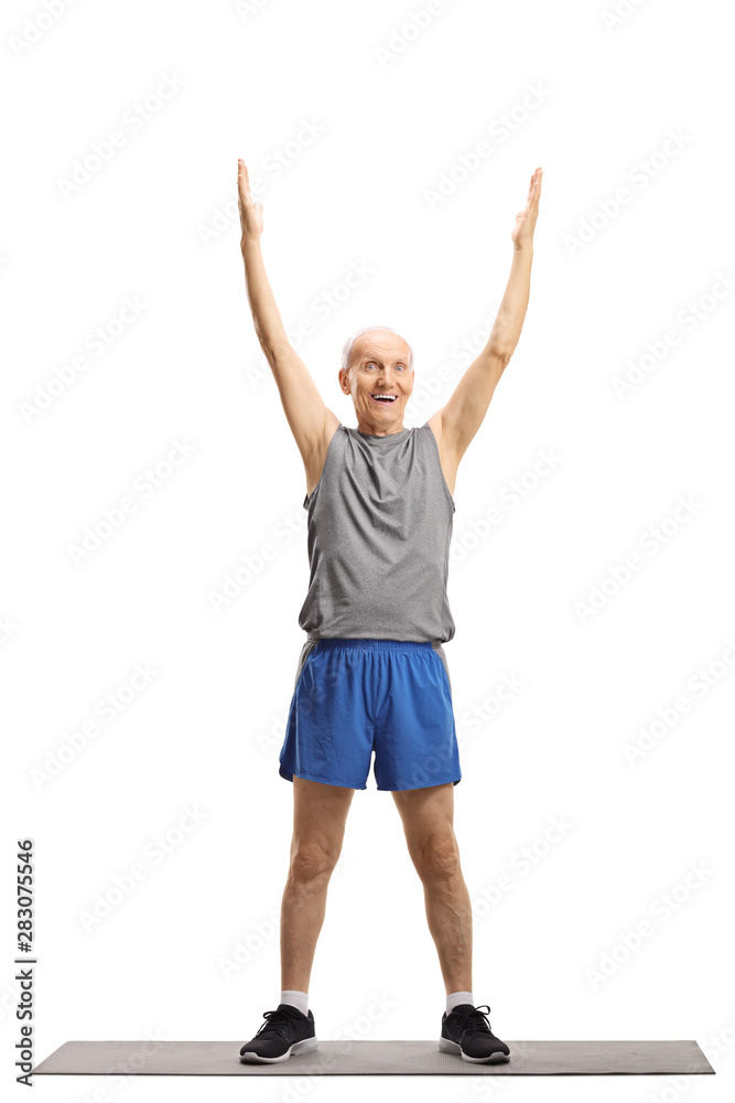 Elderly man exercising on a mat Elderly man exercising on a mat