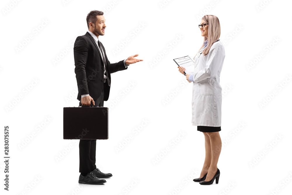 Businessman with a briefcase talking to a young female doctor Businessman with a briefcase talking to a young female doctor
