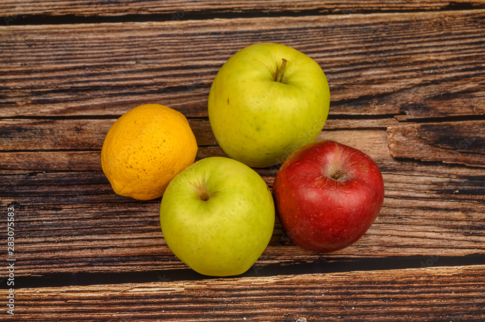 Ripe green and red apples on a wooden table background Ripe green and red apples on a wooden table background