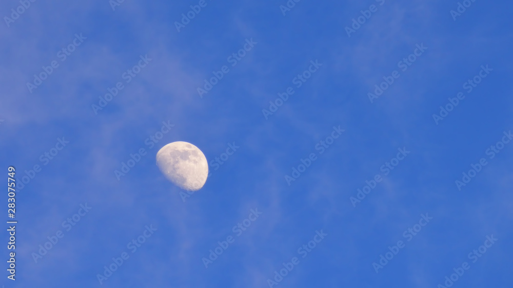 Haft moon on the blue sky background, nature concept and copy space idea Haft moon on the blue sky background, nature concept and copy space idea